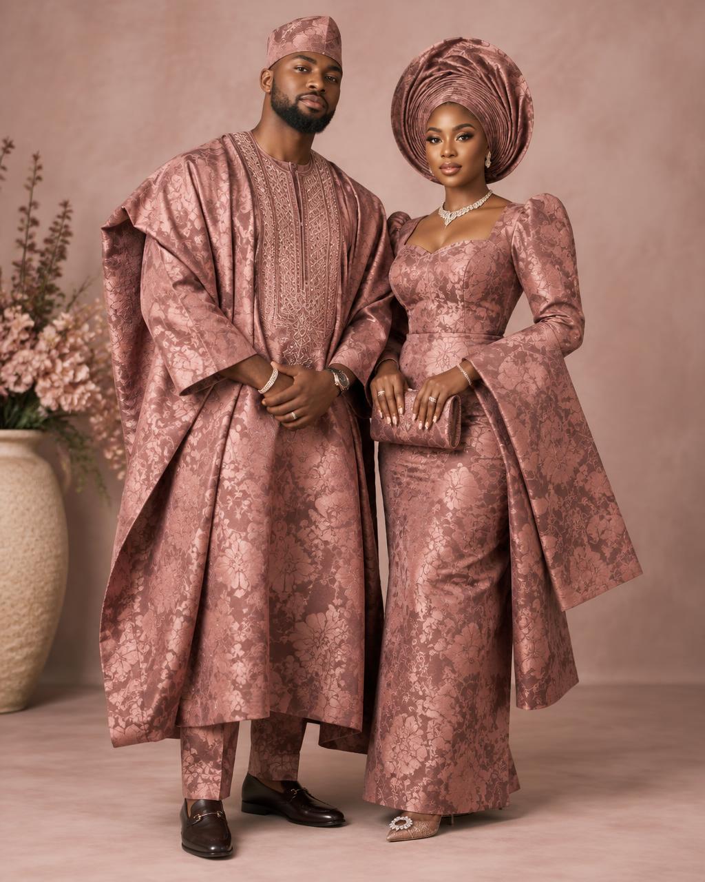 A couple dressed in dusty rose brocade attire